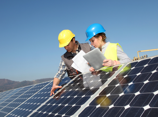 Specialists inspecting a solar panel array